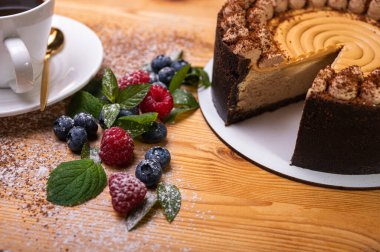 Kremalı cheesecake yakın plan, taze böğürtlen, yabanmersini ve ahududu ile süslenmiş, bayramlık yeni yıl pastası, Noel