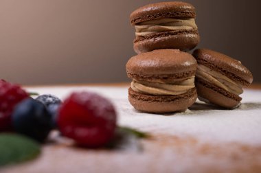 Hafif arka planda çikolatalı tatlılar, ahududu ve yaban mersinli. Noel şenliği arka planı