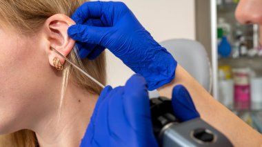 Otolaryngologist ofisi, kızın kulak tıkacı, işitme testi, doktor muayenesi.