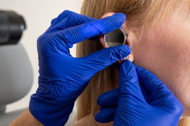 Otolaryngologist ofisi, kızın kulak tıkacı, işitme testi, doktor muayenesi.