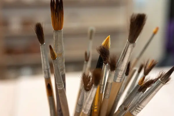 A set of tools, brushes for sculpting from clay in the workshop, drawing, at the workplace. Close up, place for writing