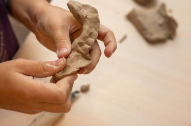 Clay, çömlek ya da el sanatları atölyesinde küçük işletme atölyesinde sanatsal bir bardak ya da kupa kalıbı üzerinde çalışıyor. Heykelde el işi ürünleri üreten yaratıcı sanatçı ya da işçilerin eli