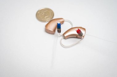 İşitme cihazı beyaz arkaplanda izole edilmiş. Yakın çekim, sağırlar için işitme cihazı, en son teknoloji.