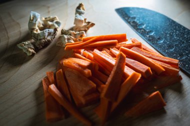 Tahta arka planda dilimlenmiş havuç ve kereviz kökü ve bıçak, yemek pişirme, yazma yeri