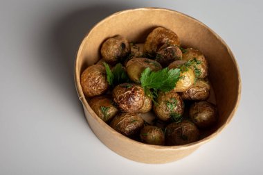 Kızarmış patatesler altın sarısı ile pişirilir. Fast food paketleri hafif arkaplanda, yazıtlar için yer.