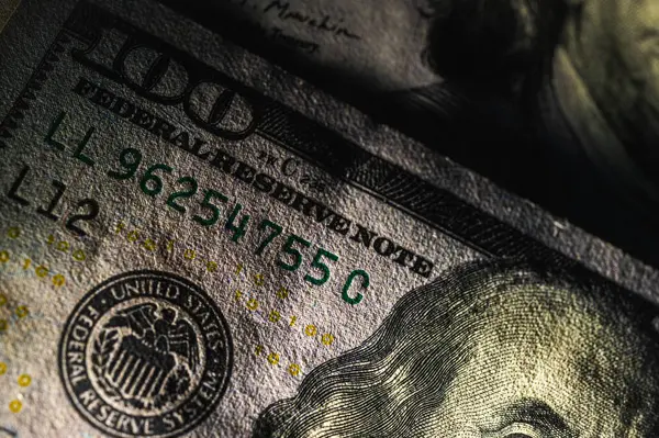 Detaylar, güvenlik özellikleri ve canlı renklerle dolu 100 dolarlık banknota yakından bakın. Finans, bankacılık ve zenginlik temsil teması, düşük anahtar, seçici odaklanma