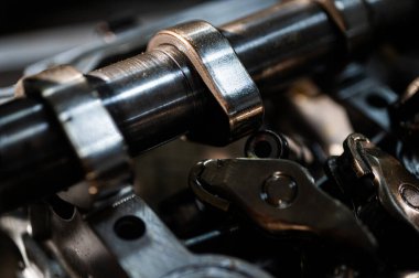 Hareket halindeki endüstriyel metal dişlilerin yakın görüntüsü, mühendisliği, makine yapımını, makine yapımı ve hassas imalatını, parçalanmış araba motorunu, yedek parçaları sembolize ediyor. Seçici odak