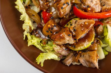 Lezzetli ızgara et salatası, taze marul, dolmalık biber, soğan ve susamlı. Lezzetli domuz etli gurme yemeği, sağlıklı yemek için mükemmel.