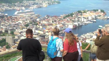 Bergen, Norway - Jun 23, 2023: Many tourists on the observation deck at the top of the Floidbanen. A beautiful top view of the port of Bergen from the mountain Floyen Floien. A birds-eye view of