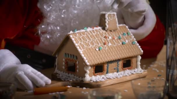 Santa Claus Decorating Gingerbread House Sweet Patterns His Residence Fireplace — Stock Video