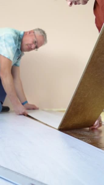 Mature Married Couple Installing New Wooden Laminate Flooring Warm Floor — Stock Video