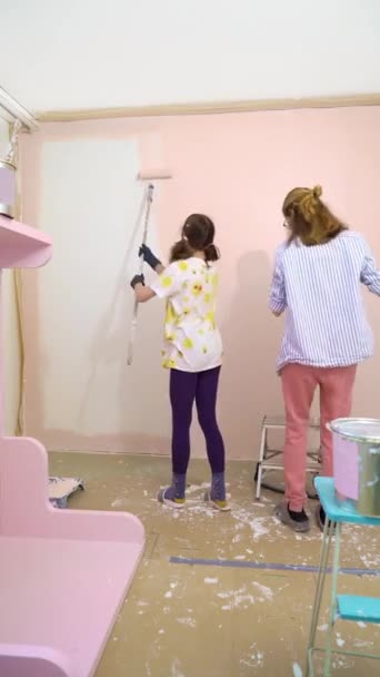 Back View Happy Mother Daughter Painting House Wall Pink Color — Stock Video