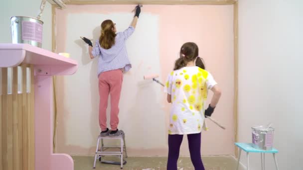 Vista Trasera Feliz Madre Hija Pintando Pared Casa Color Rosa — Vídeos de Stock