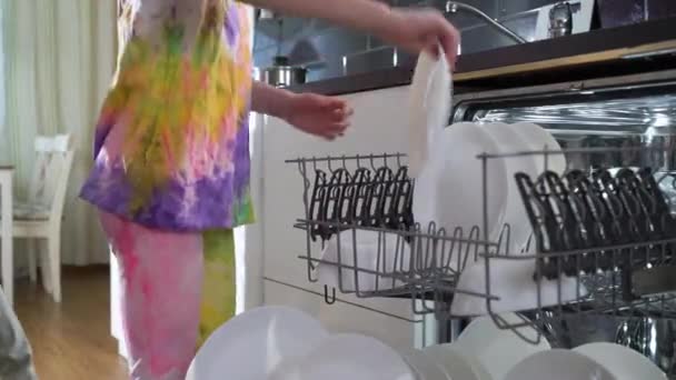 Little Girl Takes Clean Dishes Out Dishwasher Bright Sunny Kitchen — Stock Video
