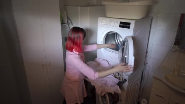 Young Woman Dyed Red Hair Loading Dirty Clothes Washing Machine Royalty Free Stock Video