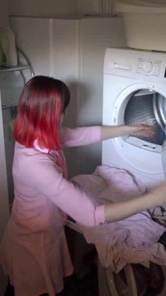 Young Woman Dyed Red Hair Loading Dirty Clothes Washing Machine Stock Footage