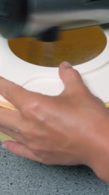 Evinin mutfağında yemek pişiren genç bir kadın. Karıştırıcı ile tatlı için pişirme ayinini çırp.