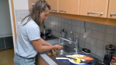 Kadın köfte pişiriyor ya da et köftesi pirzolası fırında tavada yağla kızartılıyor. Ev yemekleri, geleneksel tarifler ve aşçılık.