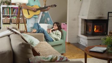 Orta yaşlı bir adam ve 12 yaşında bir kız birlikte müzik keyfi yapıyorlar. O gitar çalıyor, o da rahat bir ortamda flüt çalıyor.