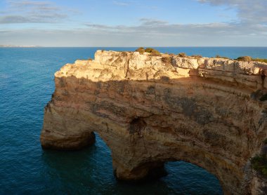 Beautiful natural limestone arch near Praia da Marinha in Lagoa, Portugal