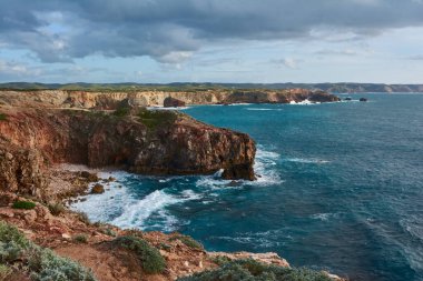 Batı Algarve 'ın tam anlamıyla. Atlantik Okyanusu 'nun dalgalarıyla kıyıya vuran kayalıklar. Praia da Zimbreirinha, Portekiz.