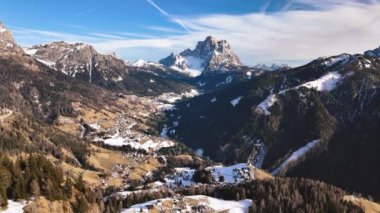 İtalya 'da Dolomite Dağları' nın kışın ilk zamanlarındaki hava panoramik manzarası. Altında küçük bir köy olan engin bir manzara.