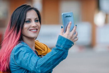 girl on the street with mobile phone or smartphone