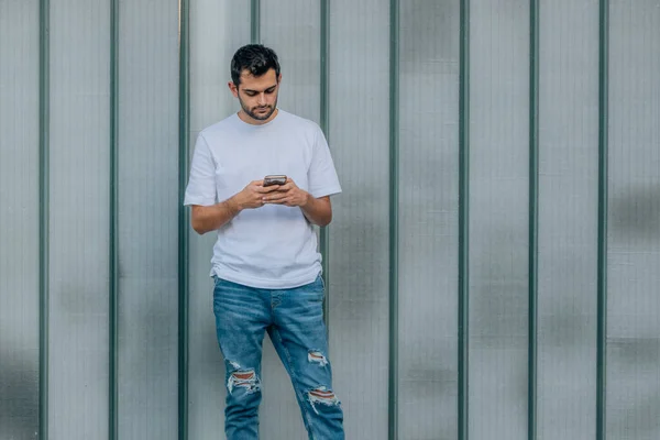 Jongeman Met Baard Mobiele Telefoon Aan Muur Straat — Stockfoto