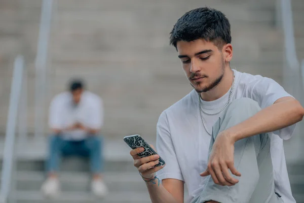 young millennials in the street with mobile phones