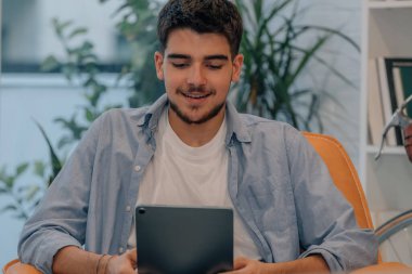young man or student at home with tablet