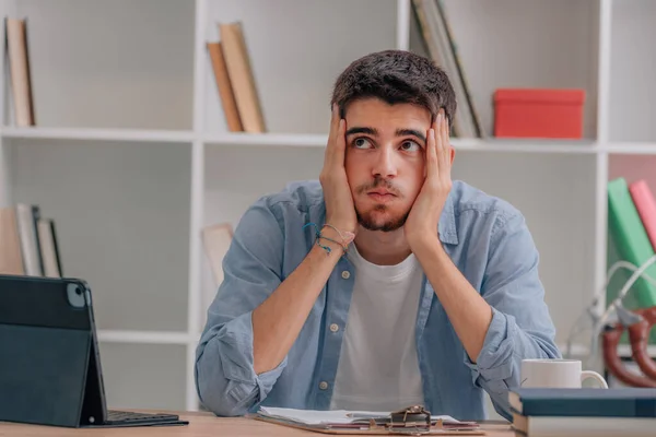 student at desk studying overwhelmed