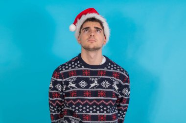 young man with christmas clothes and santa claus hat isolated