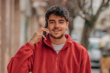 boy on the street talking on the phone