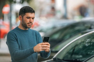 man with mobile phone buying car