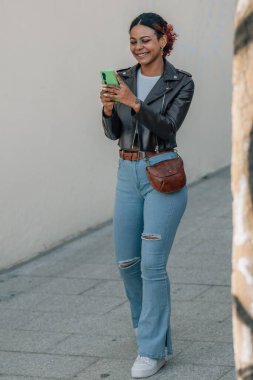 urban girl walking chatting with mobile phone