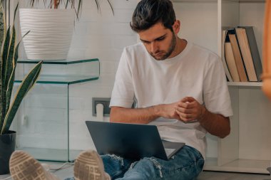young man using laptop at home or office