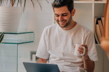 young man using laptop or computer at home