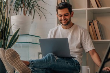 young man using laptop or computer at home