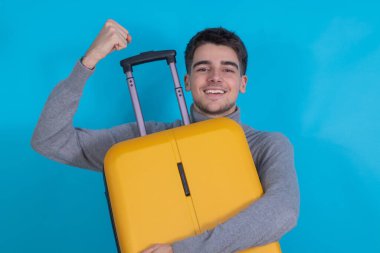 young man with suitcase isolated on background