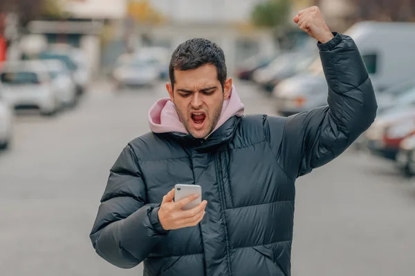Young Man Street Mobile Phone Excited Celebrating Success Warm Clothes — Photo