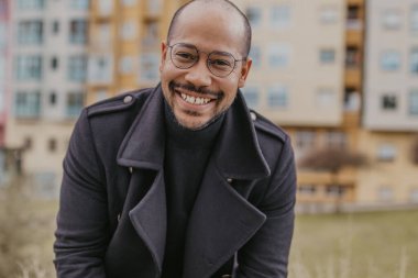 Arka planda binalar olan Latin Amerikalı bir adam.