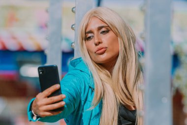 influencer in the park with mobile phone taking photos or recording