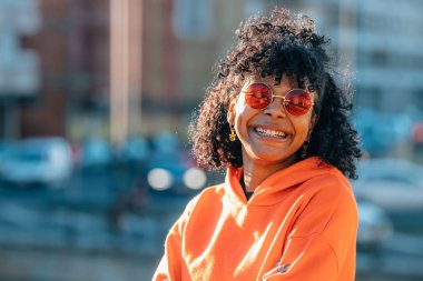 Afro-Amerikalı kız gülümsüyor.