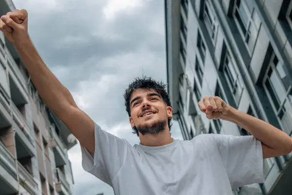 stock image young man in the street celebrating with joy