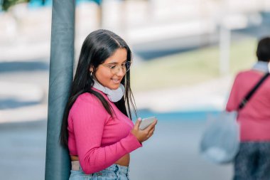 girl on the street looking at the mobile phone