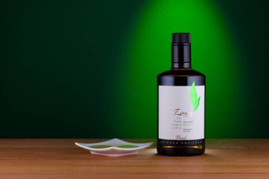 Prague,Czech Republic -  10 January, 2023: Bottle of Lenis Extra Virgin Olive Oil on the green background. Extra Virgin Olive Oil is a good olive oil for your daily cooking at a reasonable price.