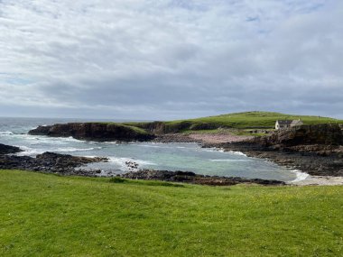 Amazing Clachtoll Beach in Lochinver, Scotland. Clachtoll Beach is a popular beach with some rugged terrain, including the Split Rocks