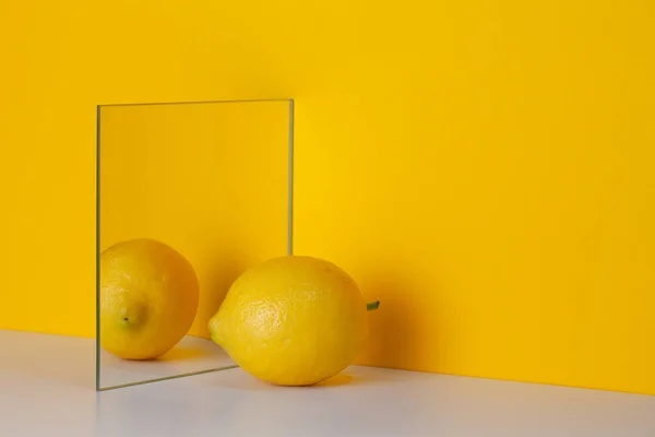 Yellow Lemon Reflected Mirror Yellow Background Copy Space Shadows Healthy — Zdjęcie stockowe