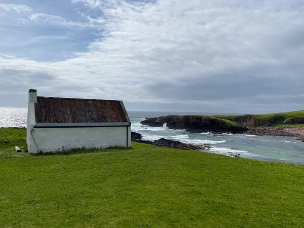 Amazing Clachtoll Beach in Lochinver, Scotland. Clachtoll Beach is a popular beach with some rugged terrain, including the Split Rocks