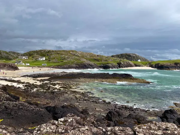 Amazing Clachtoll Beach in Lochinver, Scotland. Clachtoll Beach is a popular beach with some rugged terrain, including the Split Rocks